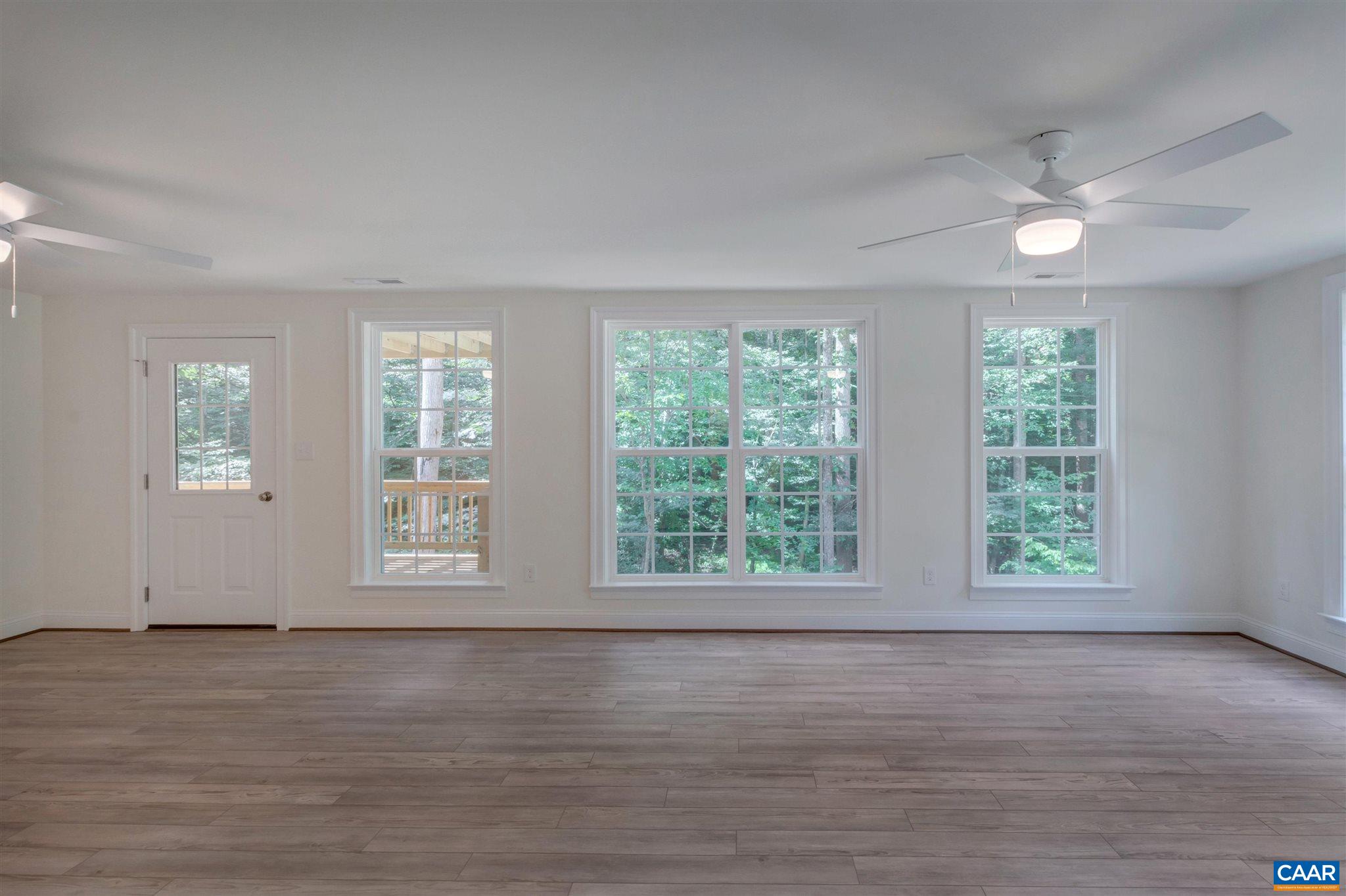 312 Jonquil Road Ruckersville, VA 22968 - Photo 18 of 34 a view of an empty room with wooden floor and a window