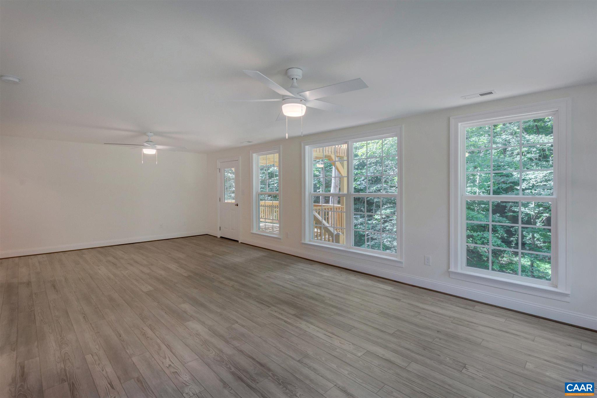 312 Jonquil Road Ruckersville, VA 22968 - Photo 19 of 34 a view of an empty room with wooden floor and a window
