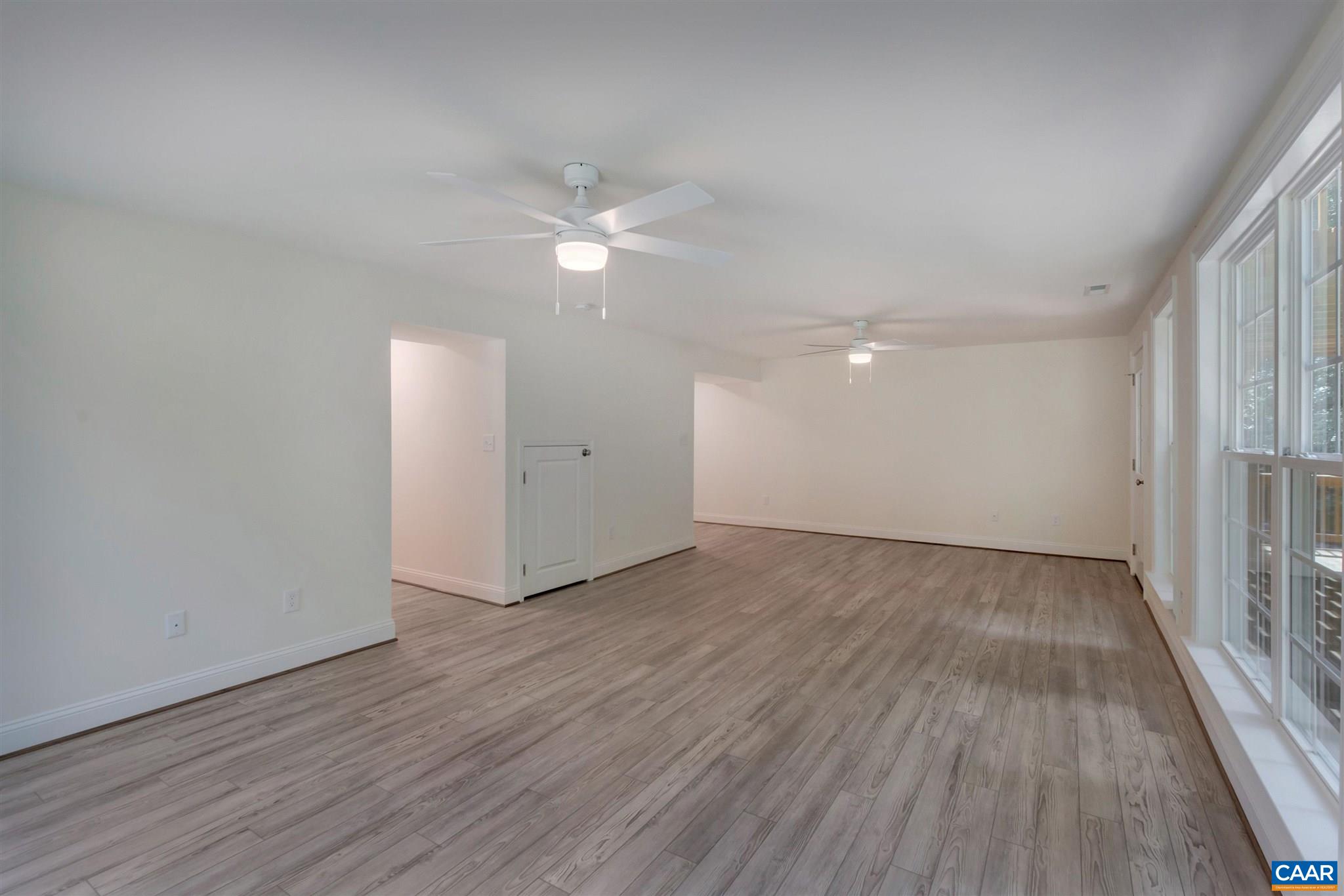 312 Jonquil Road Ruckersville, VA 22968 - Photo 20 of 34 an empty room with wooden floor fan and windows