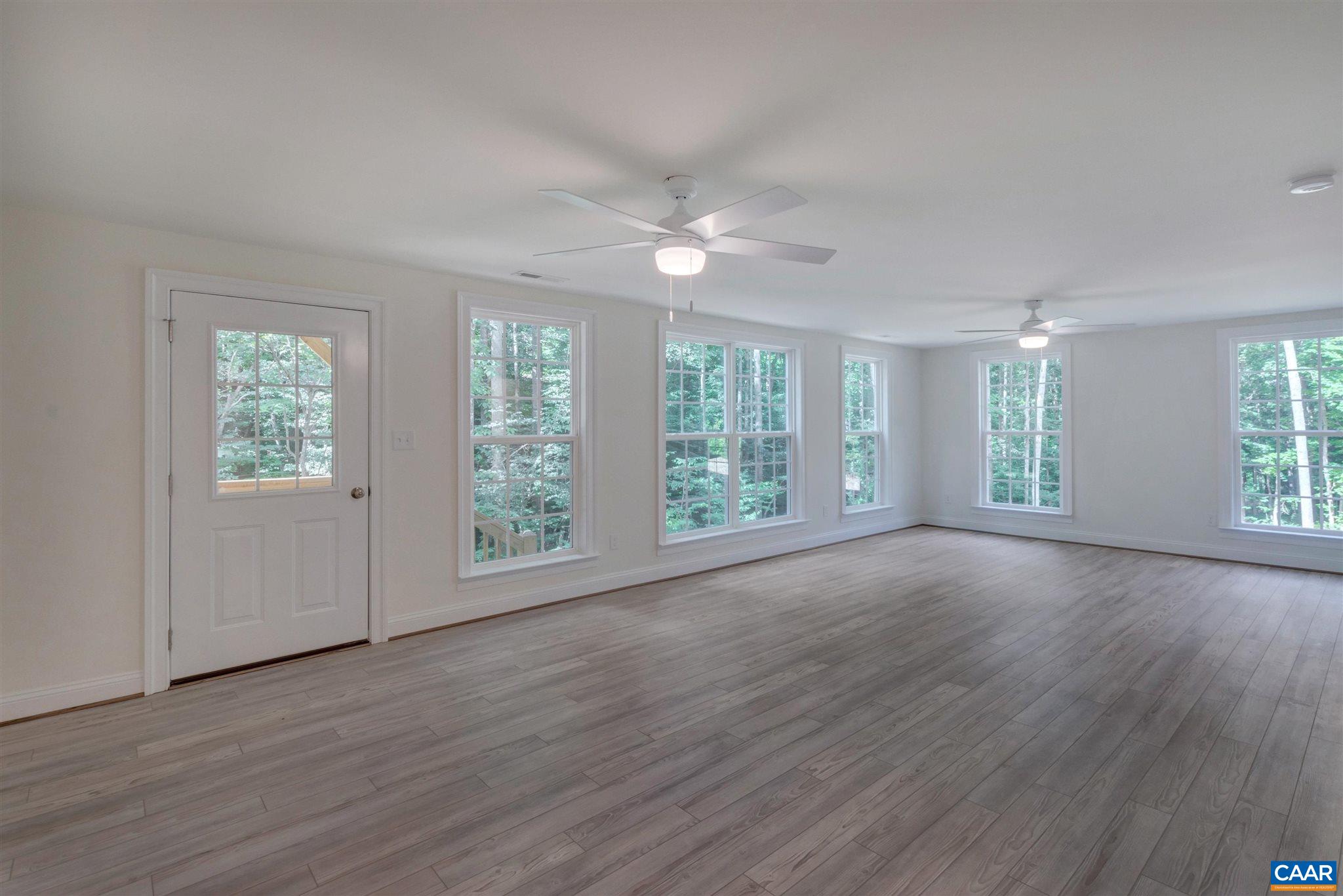312 Jonquil Road Ruckersville, VA 22968 - Photo 22 of 34 an empty room with wooden floor and windows