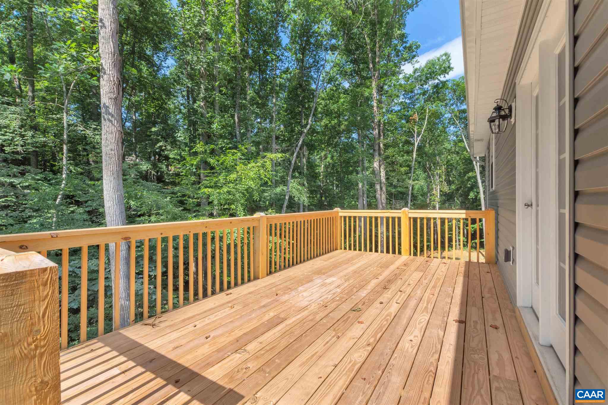 312 Jonquil Road Ruckersville, VA 22968 - Photo 29 of 34 a balcony with trees in front of it