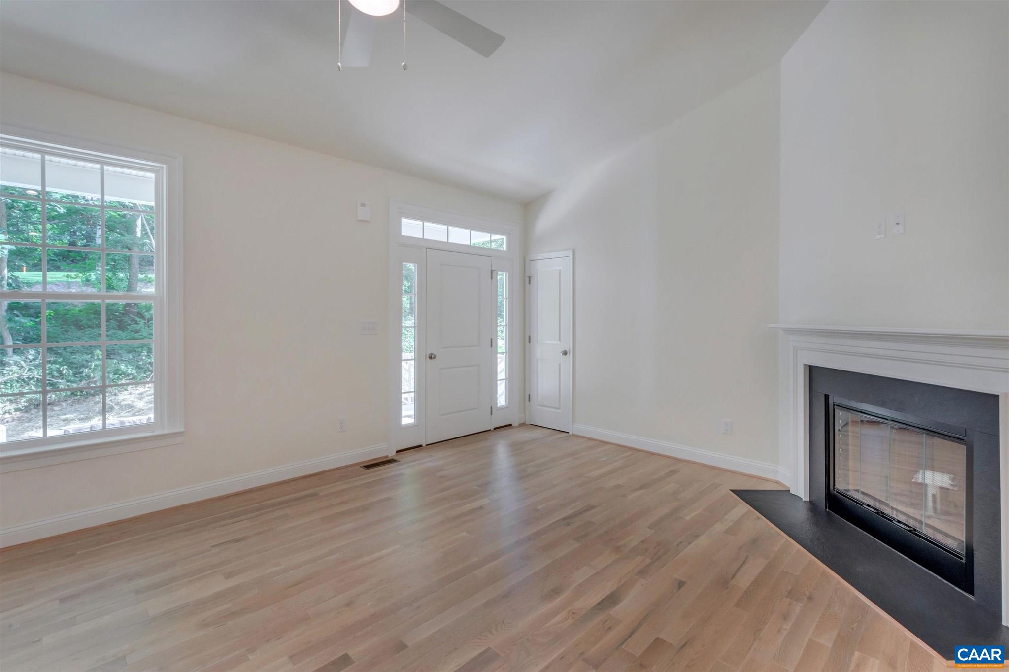 312 Jonquil Road Ruckersville, VA 22968 - Photo 4 of 34 a view of an empty room with wooden floor and a window