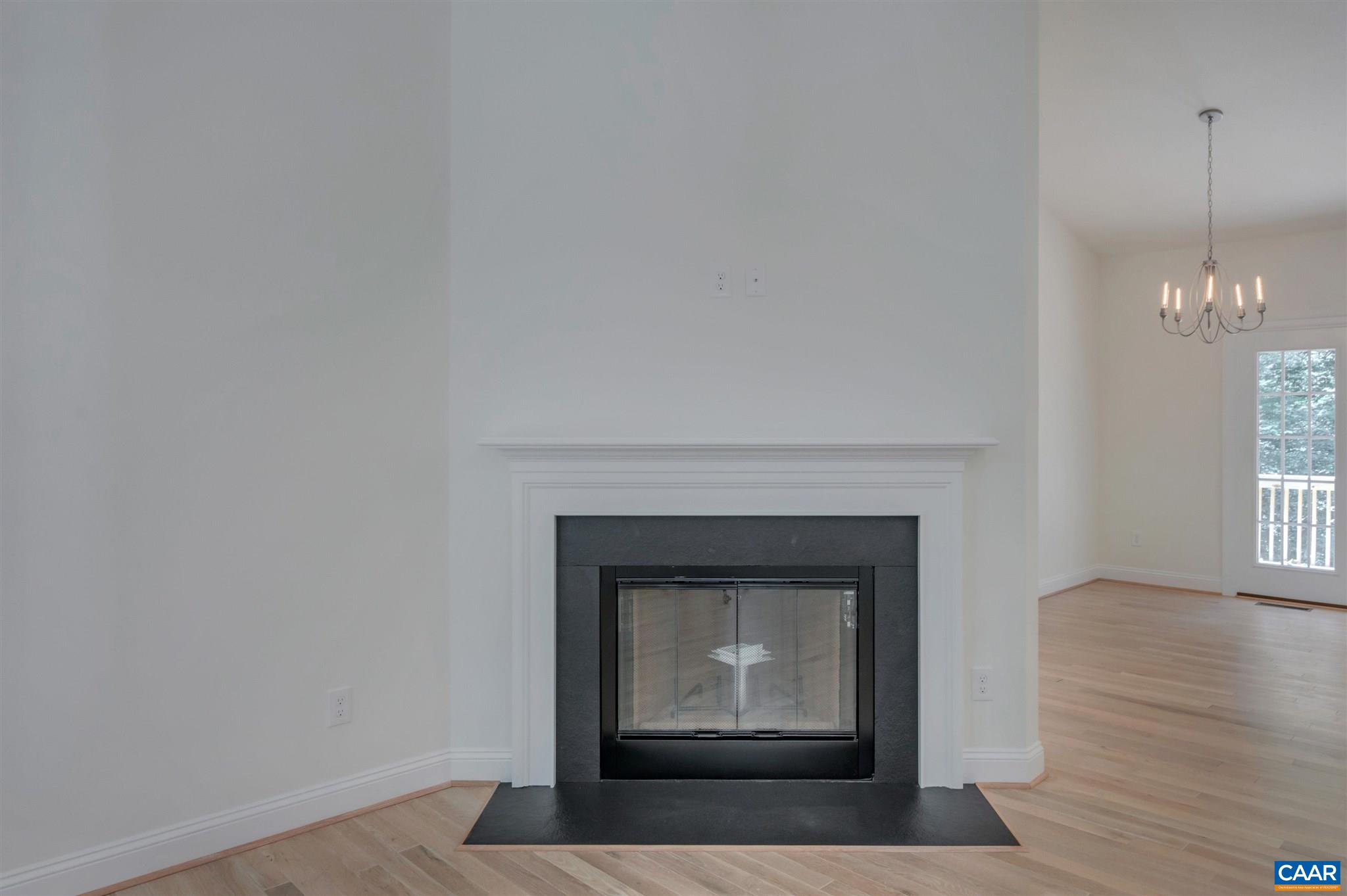 312 Jonquil Road Ruckersville, VA 22968 - Photo 6 of 34 a living room with a fireplace and wooden floor