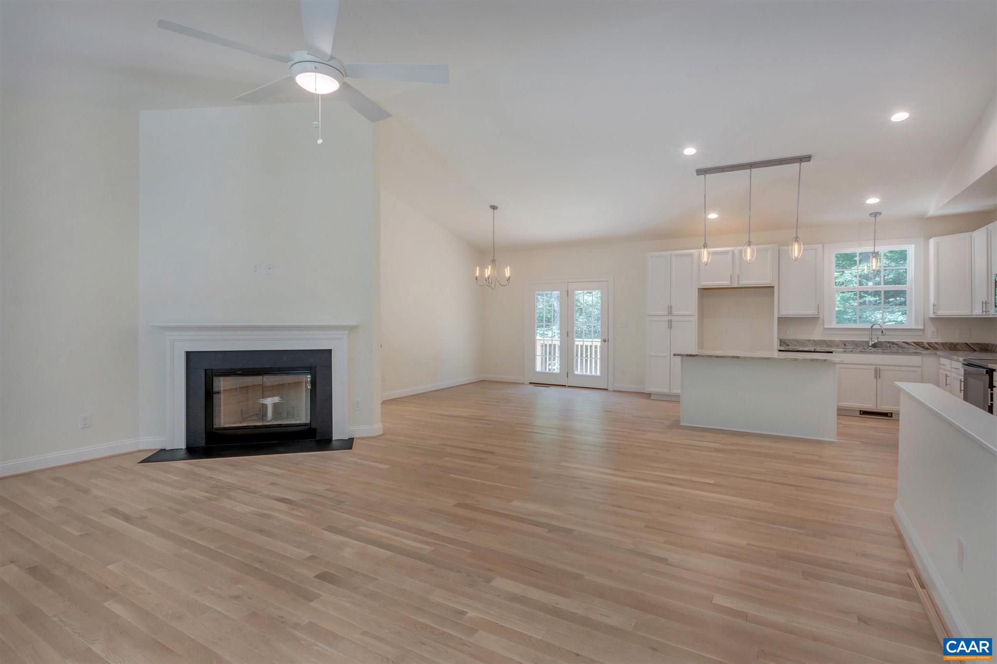 312 Jonquil Road Ruckersville, VA 22968 - Photo 7 of 34 a view of an empty room and kitchen with wooden floor and a window