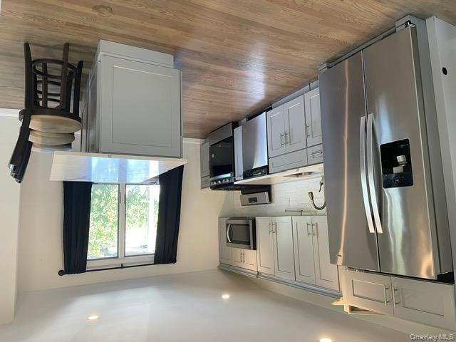 2949 Sunrise Highway Islip Terrace, NY 11752 - Photo 1 of 1 a kitchen with stainless steel appliances granite countertop a refrigerator a stove a sink dishwasher and a refrigerator with wooden floor