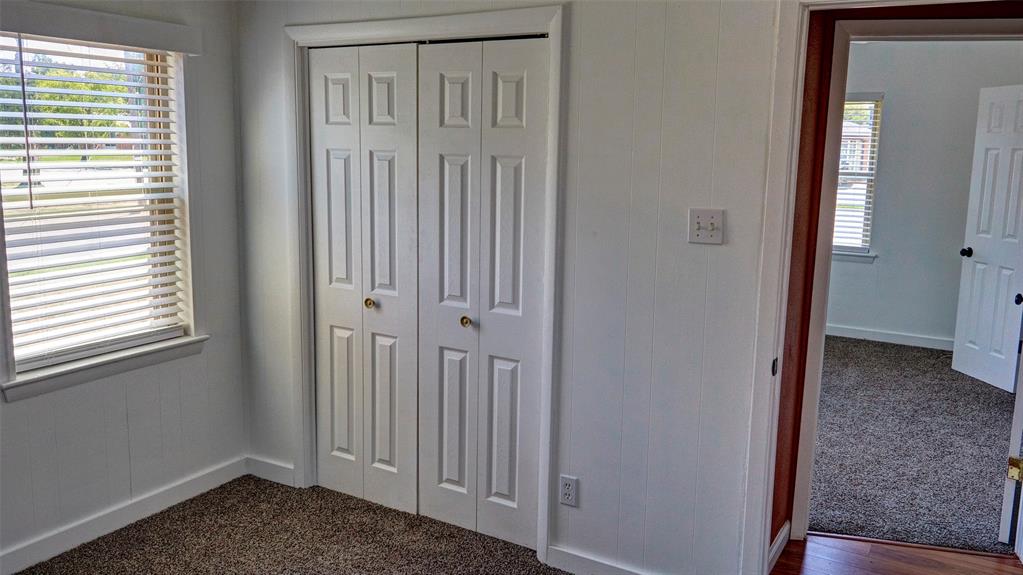 2612 West Rochelle Road Irving, TX 75062 - Photo 12 of 29 Unfurnished bedroom with dark colored carpet and a closet