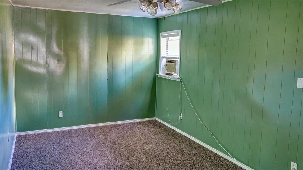 2612 West Rochelle Road Irving, TX 75062 - Photo 18 of 29 Carpeted bonus room featuring wood walls and a ceiling fan