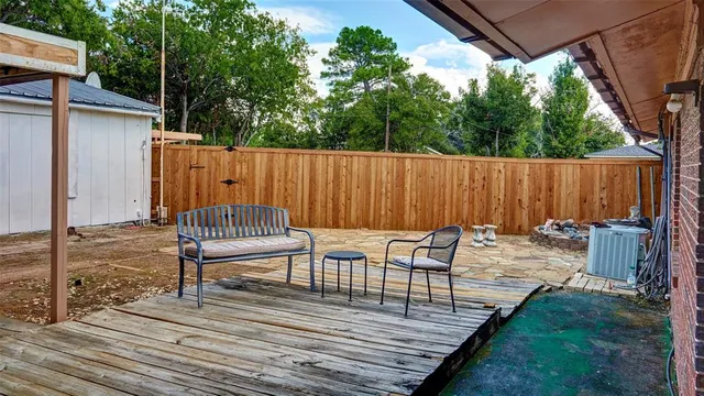 a view of a wooden deck and a yard