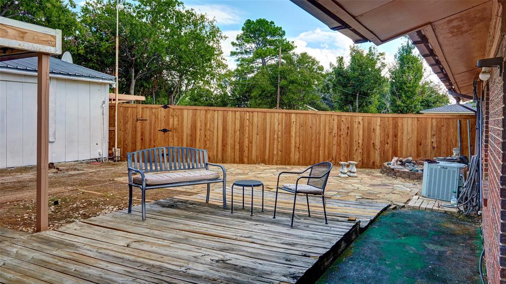 2612 West Rochelle Road Irving, TX 75062 - Photo 21 of 29 Wooden deck with a patio area and a fenced backyard