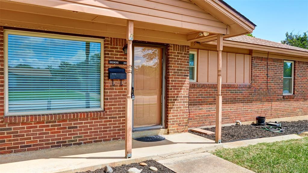 2612 West Rochelle Road Irving, TX 75062 - Photo 3 of 29 Doorway to property with brick siding