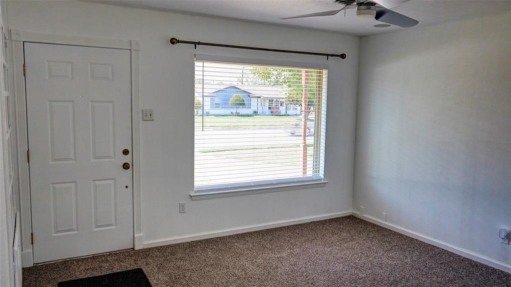 2612 West Rochelle Road Irving, TX 75062 - Photo 4 of 29 Carpeted living room with baseboards and ceiling fan