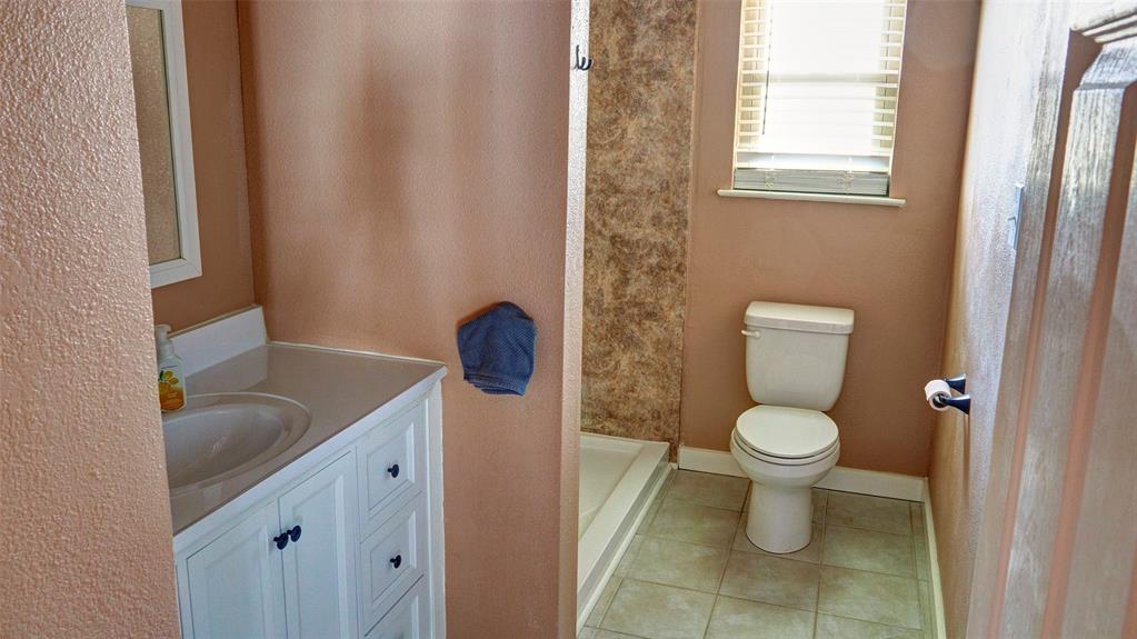 2612 West Rochelle Road Irving, TX 75062 - Photo 7 of 29 Bathroom with vanity, light tile patterned flooring, and walk in shower