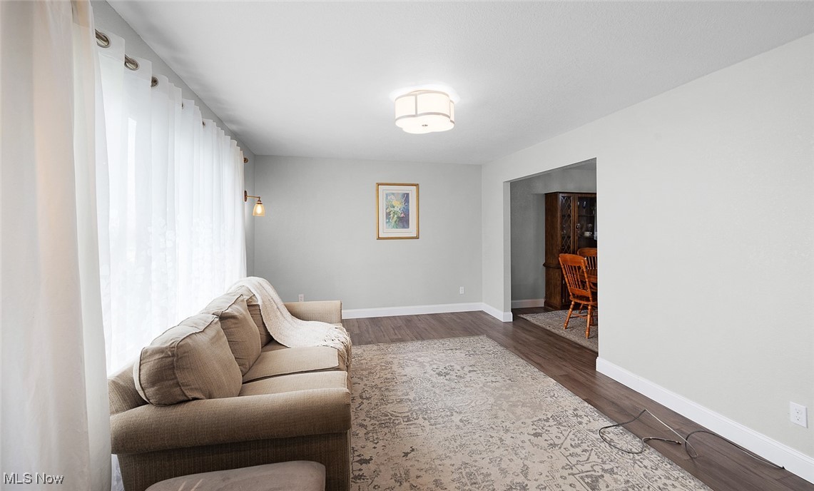 3913 Silsby Road Cleveland, OH 44118 - Photo 9 of 26 Living room featuring dark wood finished floors and baseboards
