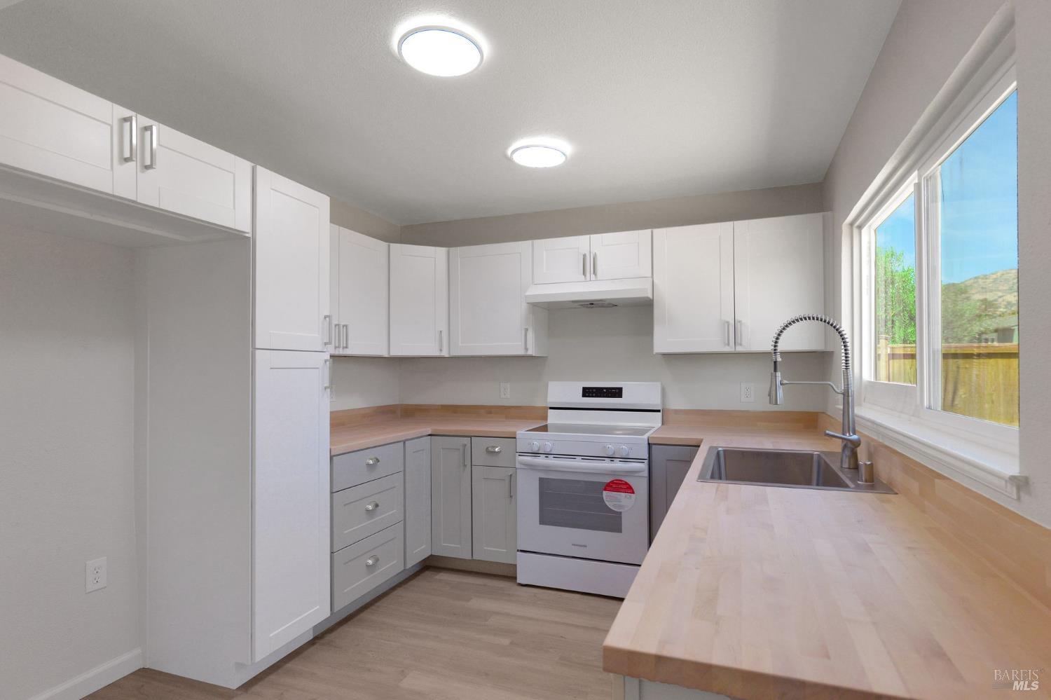 1120 Soda Canyon Road Napa, CA 94558 - Photo 15 of 38 a kitchen with a sink cabinets and window