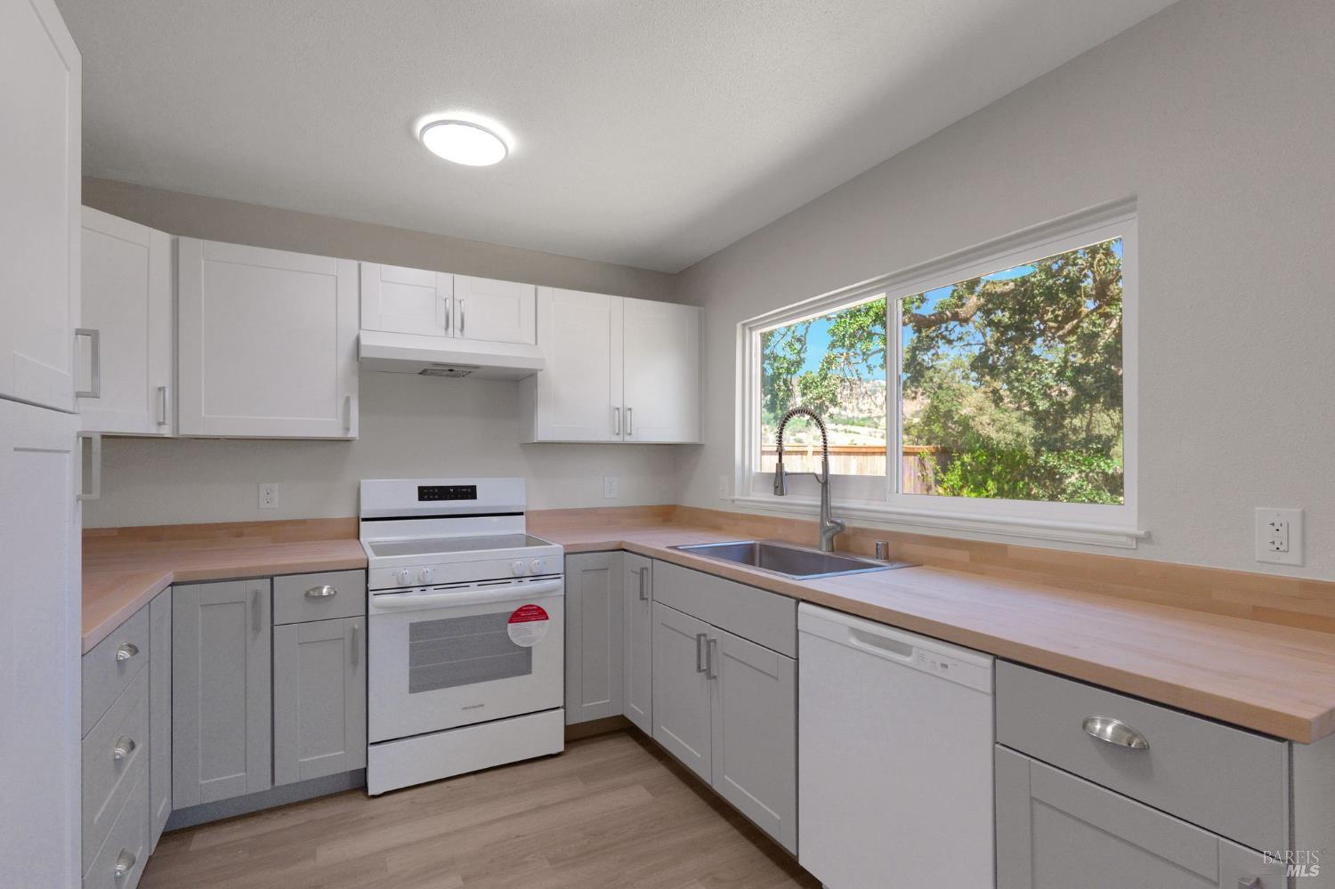 1120 Soda Canyon Road Napa, CA 94558 - Photo 16 of 38 a kitchen with appliances cabinets and a large window