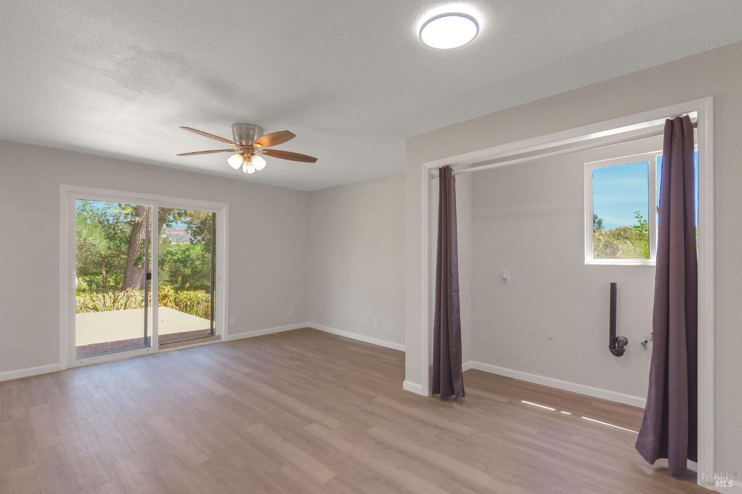 1120 Soda Canyon Road Napa, CA 94558 - Photo 21 of 38 an empty room with wooden floor and windows
