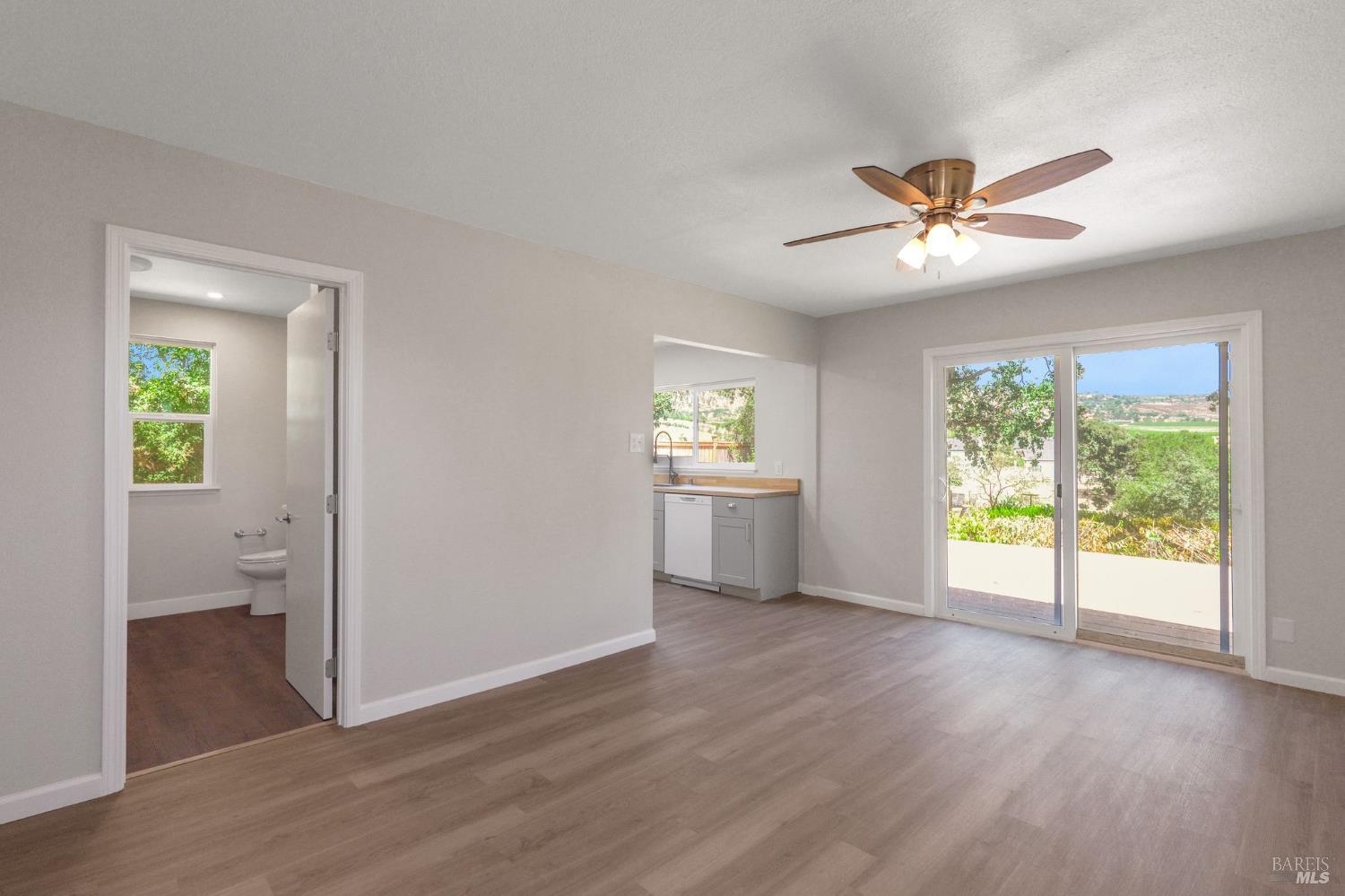 1120 Soda Canyon Road Napa, CA 94558 - Photo 23 of 38 a view of an empty room with a window and wooden floor