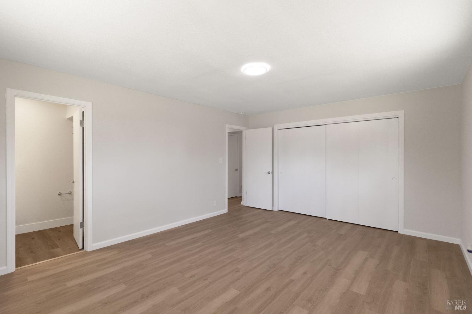 1120 Soda Canyon Road Napa, CA 94558 - Photo 26 of 38 an empty room with wooden floor and windows