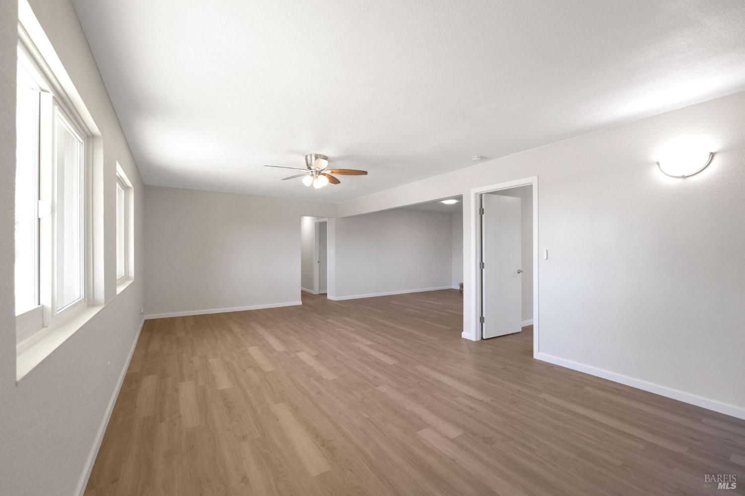 1120 Soda Canyon Road Napa, CA 94558 - Photo 29 of 38 an empty room with wooden floor and windows