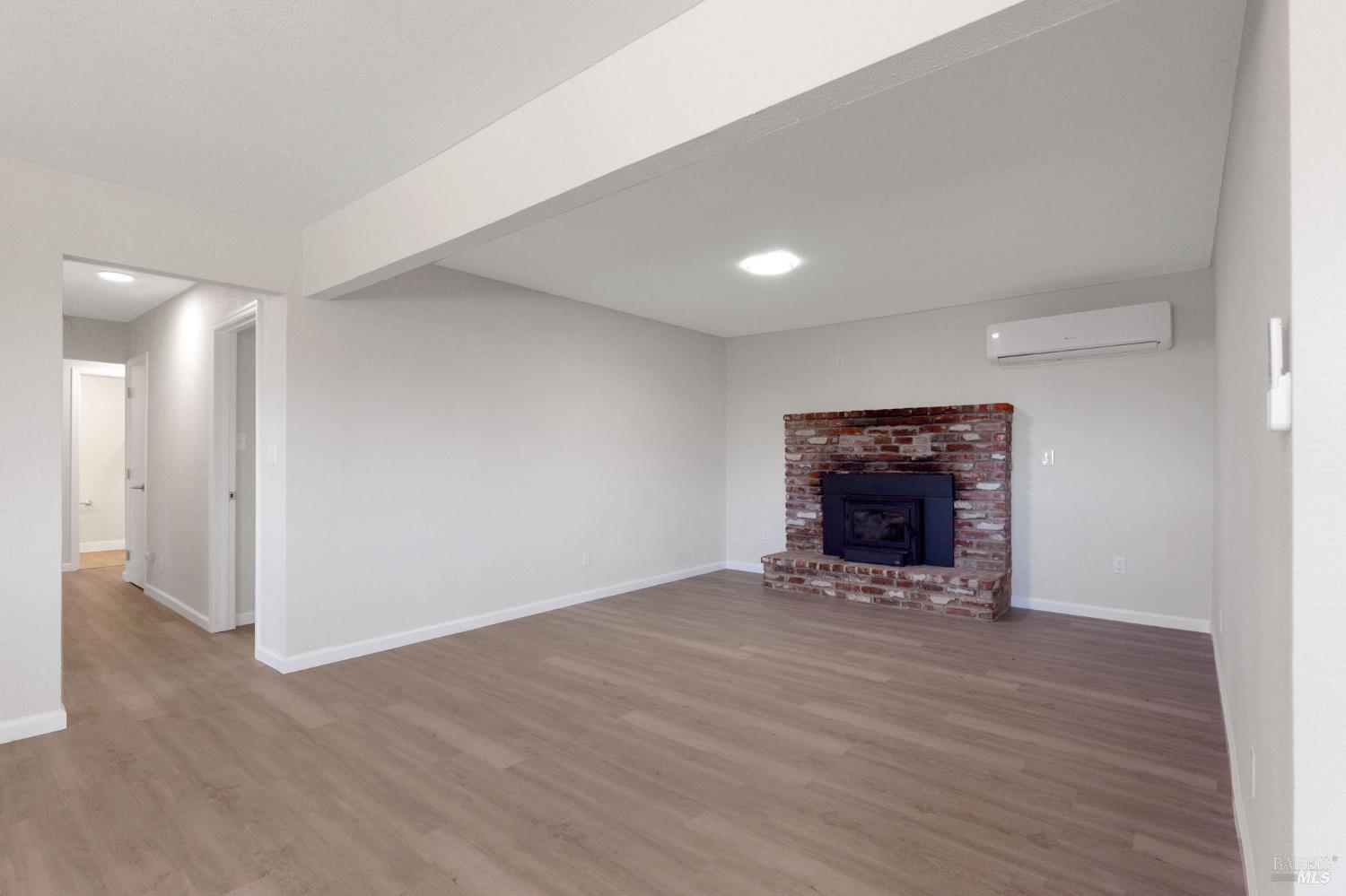 1120 Soda Canyon Road Napa, CA 94558 - Photo 9 of 38 a view of an empty room with a fireplace and a window