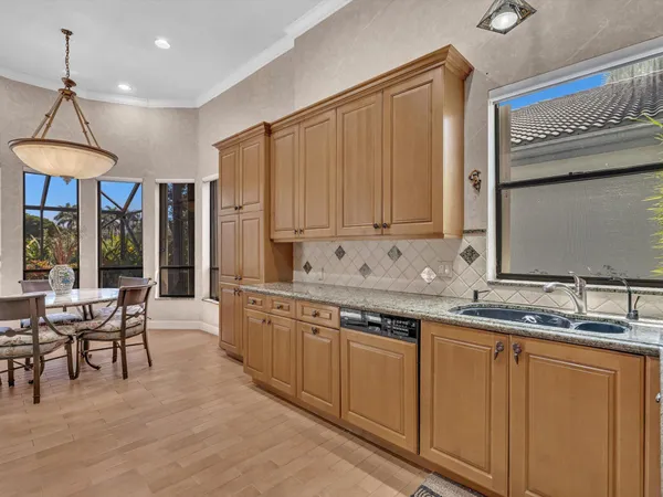 a kitchen with stainless steel appliances granite countertop a sink and cabinets