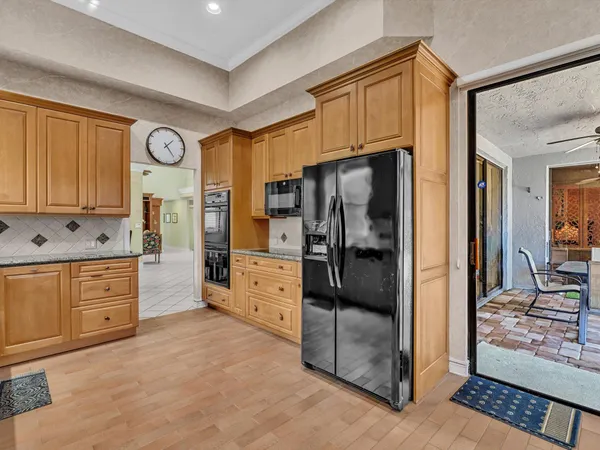a kitchen with stainless steel appliances a refrigerator and cabinets
