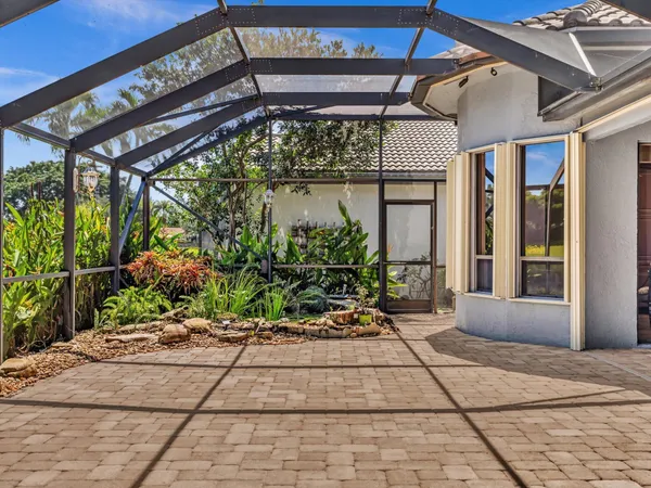 a view of a chairs and bench in the patio