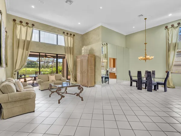 a living room with furniture and large windows