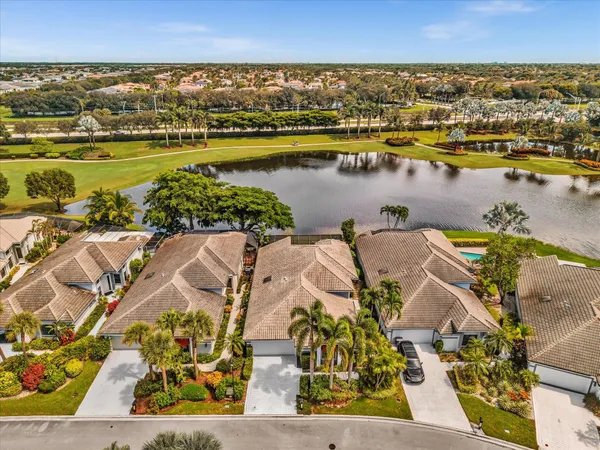 an aerial view of a residential houses with outdoor space and swimming pool