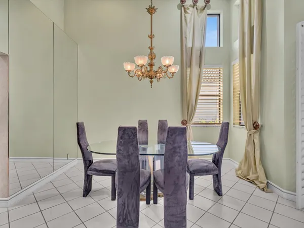 a view of a dining room with furniture and chandelier