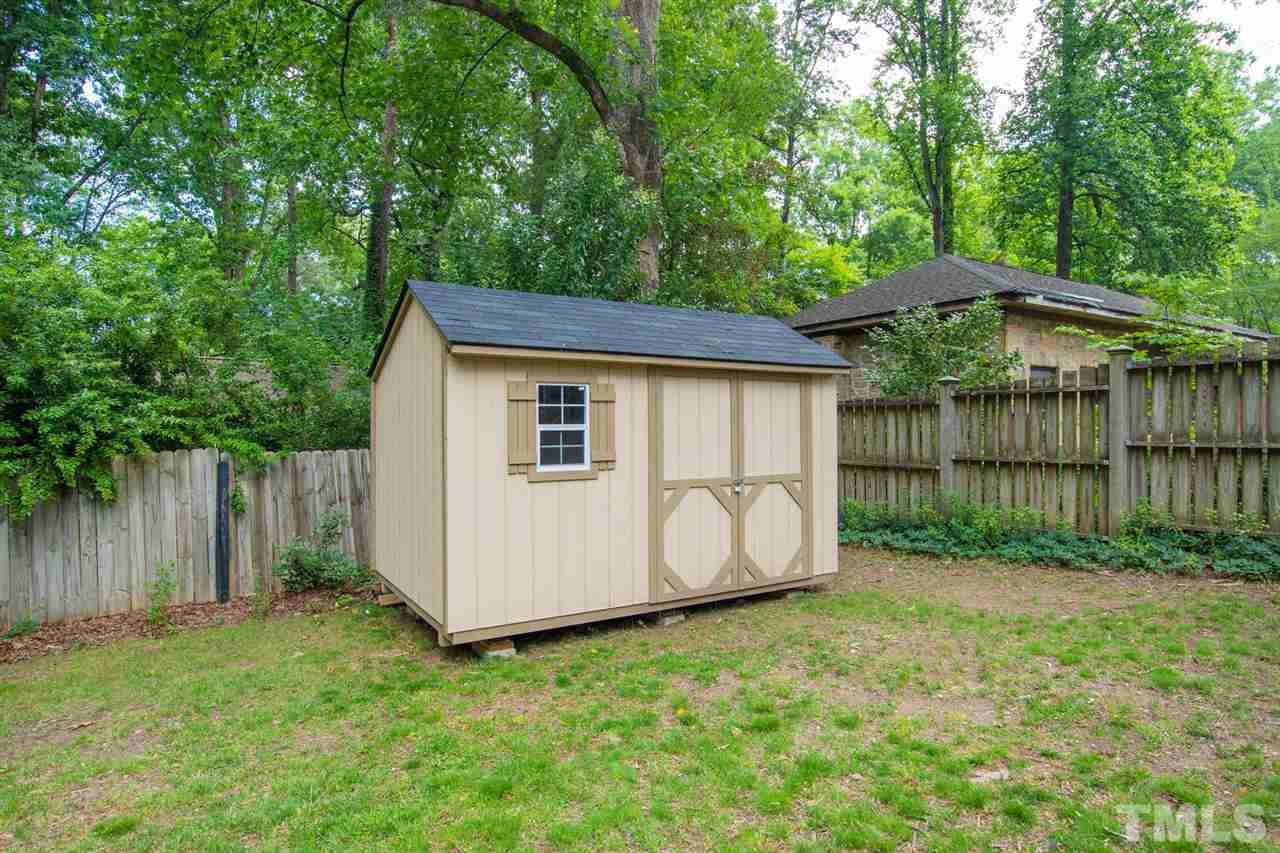902 Lake Boone Trail Raleigh, NC 27607 - Photo 8 of 30 a backyard of a house with lawn chairs and wooden fence