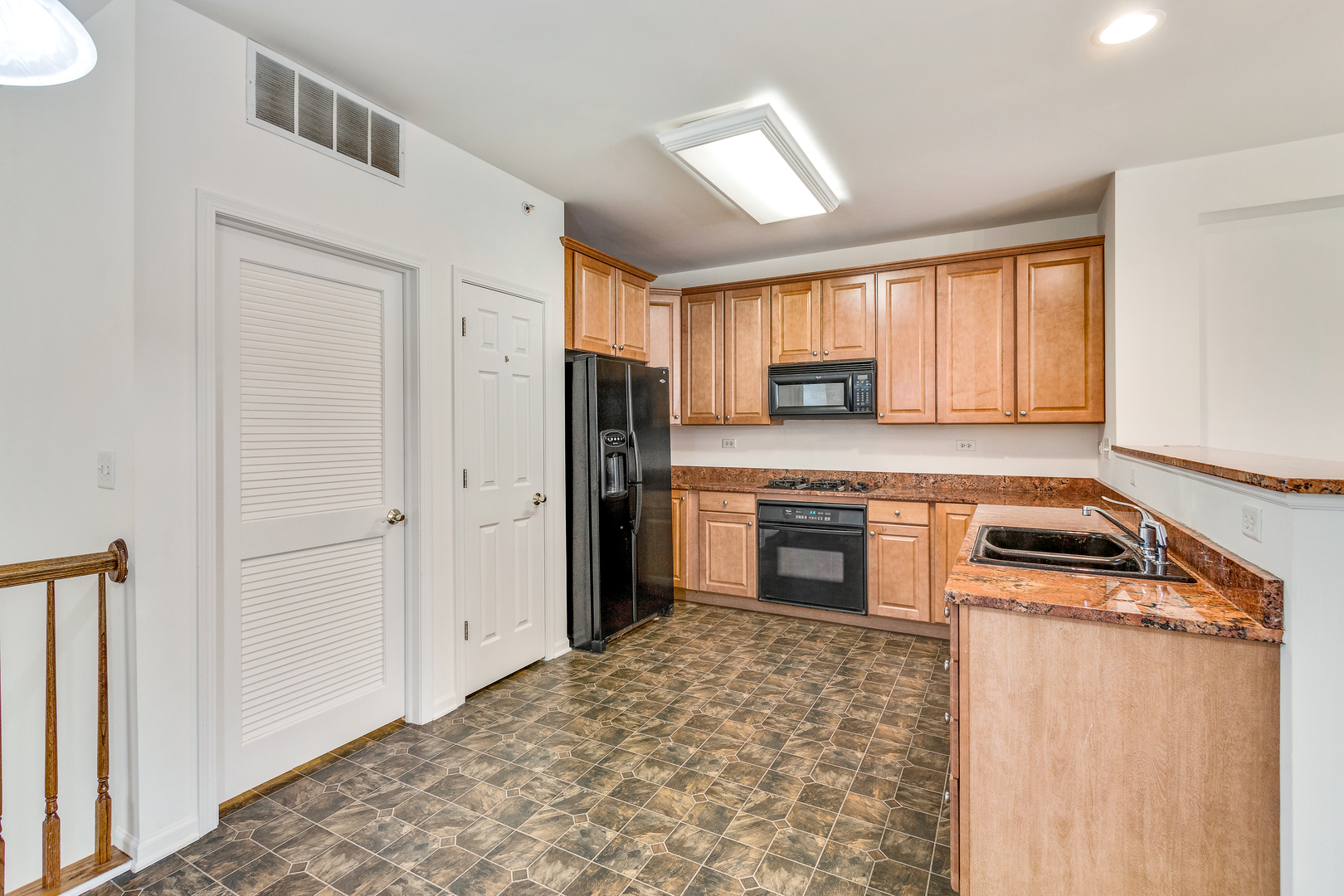 1391 Scarboro Road, Unit 201 Schaumburg, IL 60193 - Photo 9 of 20 a kitchen with a refrigerator and a stove top oven