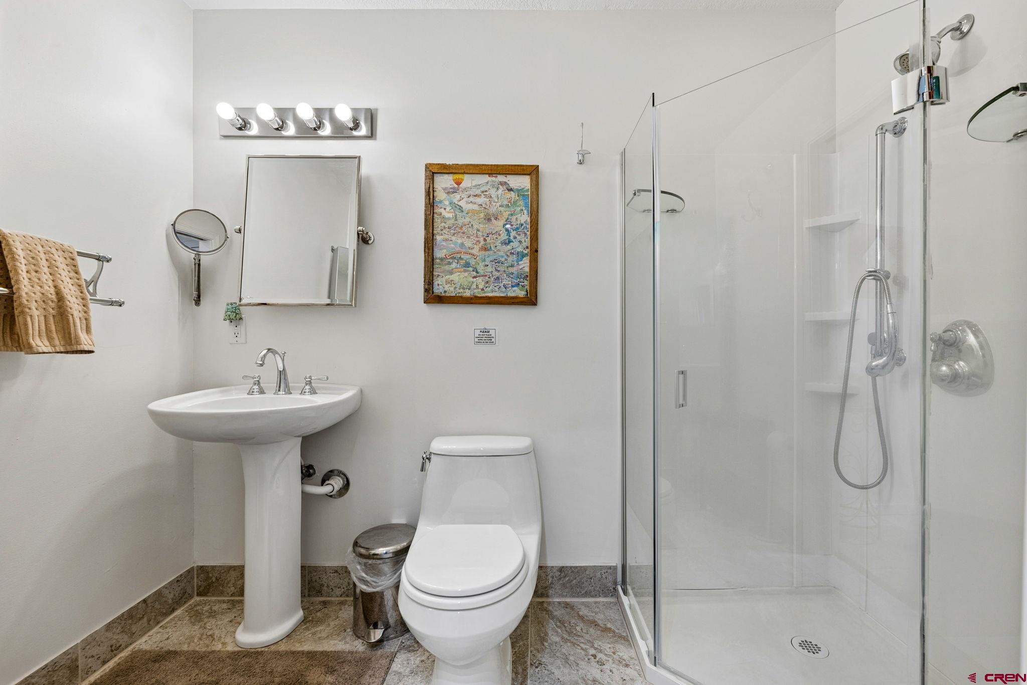 395 Sheol Street, Unit 117 Durango, CO 81301 - Photo 14 of 28 a bathroom with a toilet sink and shower