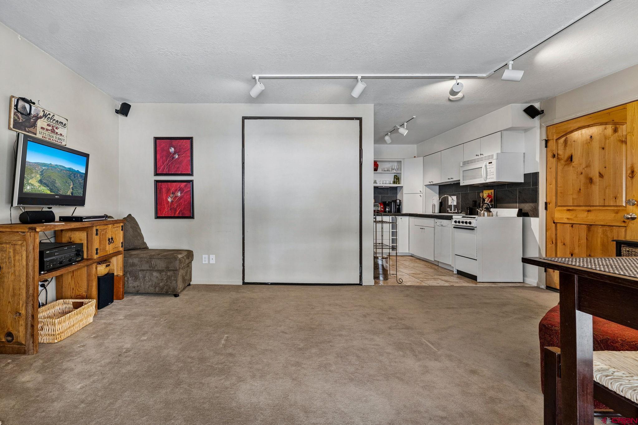 395 Sheol Street, Unit 117 Durango, CO 81301 - Photo 6 of 28 a view of kitchen with furniture and flat screen tv