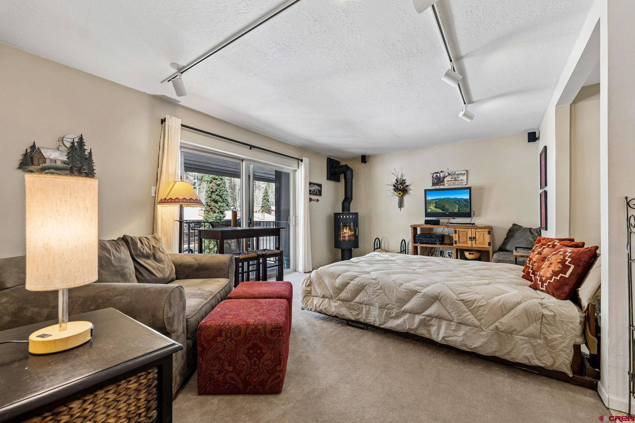 395 Sheol Street, Unit 117 Durango, CO 81301 - Photo 8 of 28 a bedroom with a bed and glass window
