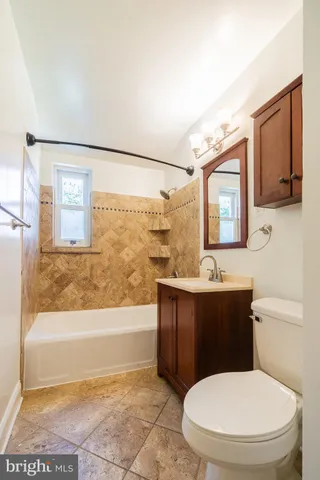a bathroom with a toilet a sink and bathtub