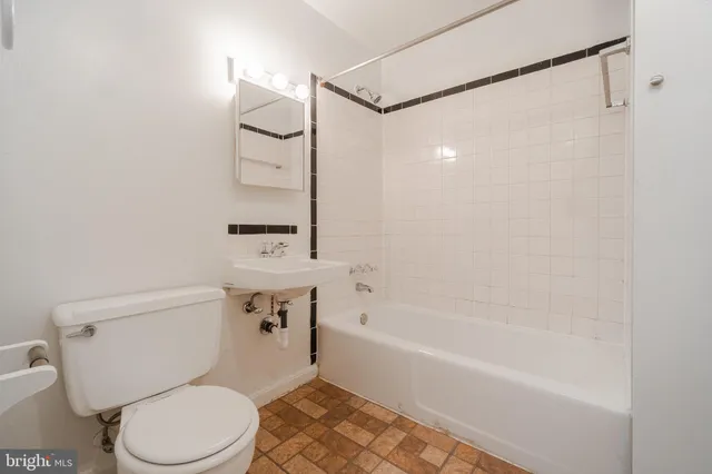 a bathroom with a toilet a sink and bathtub