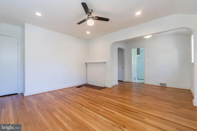 a view of an empty room with wooden floor