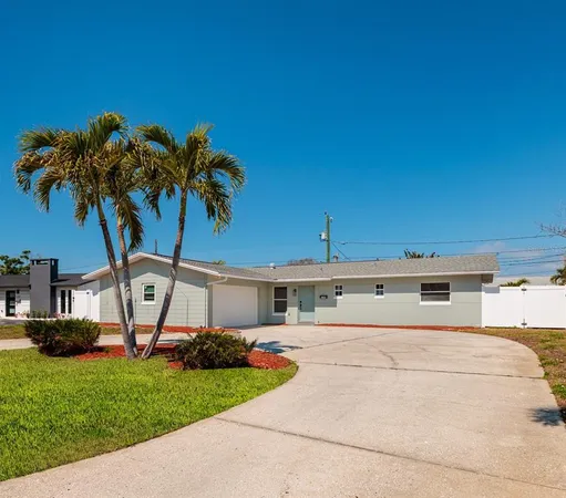a view of a backyard with a garden and entertaining space