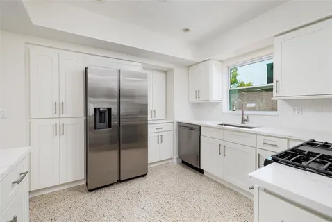 a kitchen with a stove sink and refrigerator