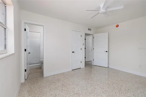 a view of room with closet and a ceiling fan