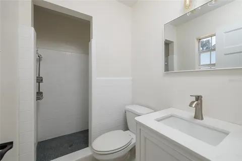 a white toilet sitting next to a bathroom sink