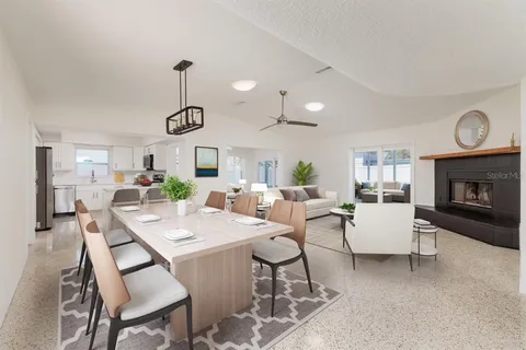 a very nice looking dining room with furniture window and wooden floor