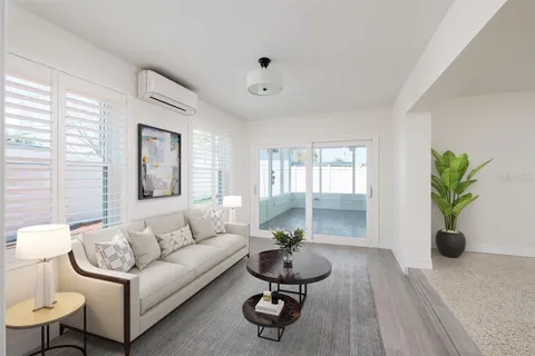 a living room with furniture potted plant and window