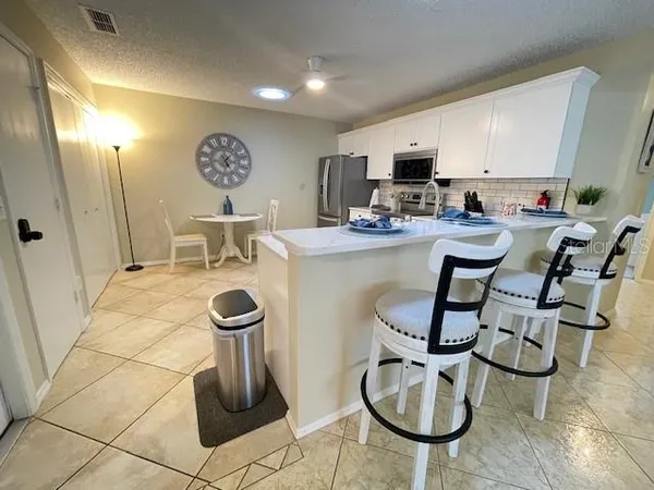 a view of a kitchen with kitchen island dining table and chairs