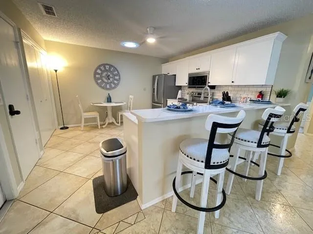a view of a kitchen with kitchen island dining table and chairs