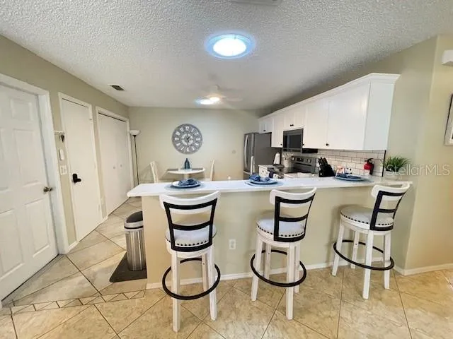 a kitchen with stainless steel appliances kitchen island granite countertop a sink and cabinets