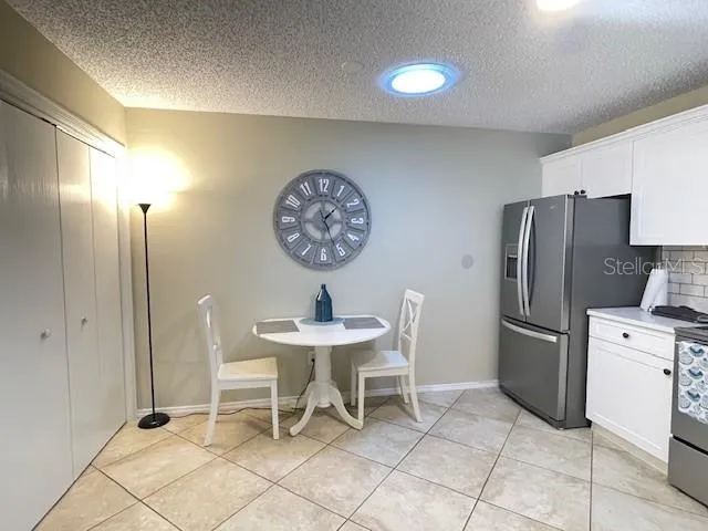a kitchen with stainless steel appliances a refrigerator and a table