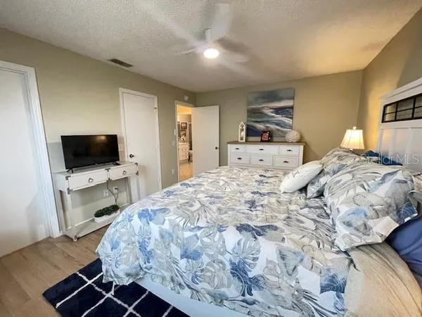 a bedroom with a bed and a flat screen tv