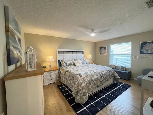 a bedroom with a bed and wooden floor